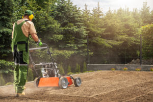 Professional gardener aerating