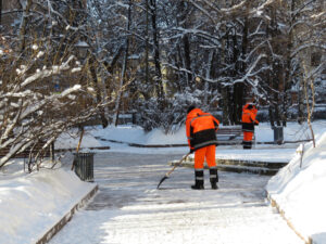 Workers clearing the ice and snow from the road